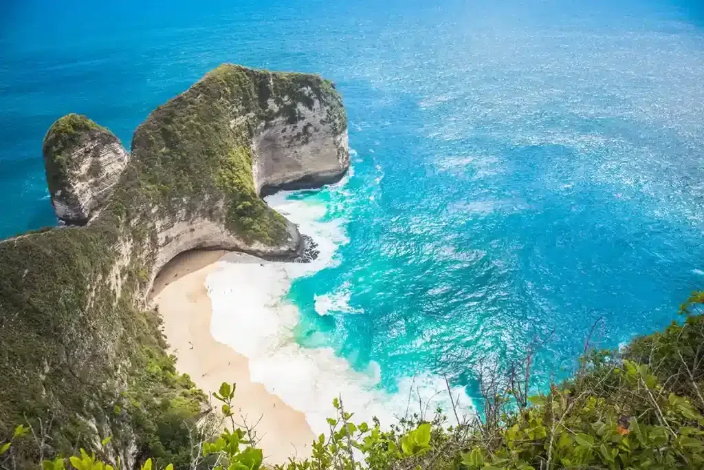 Aerial view of the Kelingking Beach headland and its white sand cove, Nusa Penida